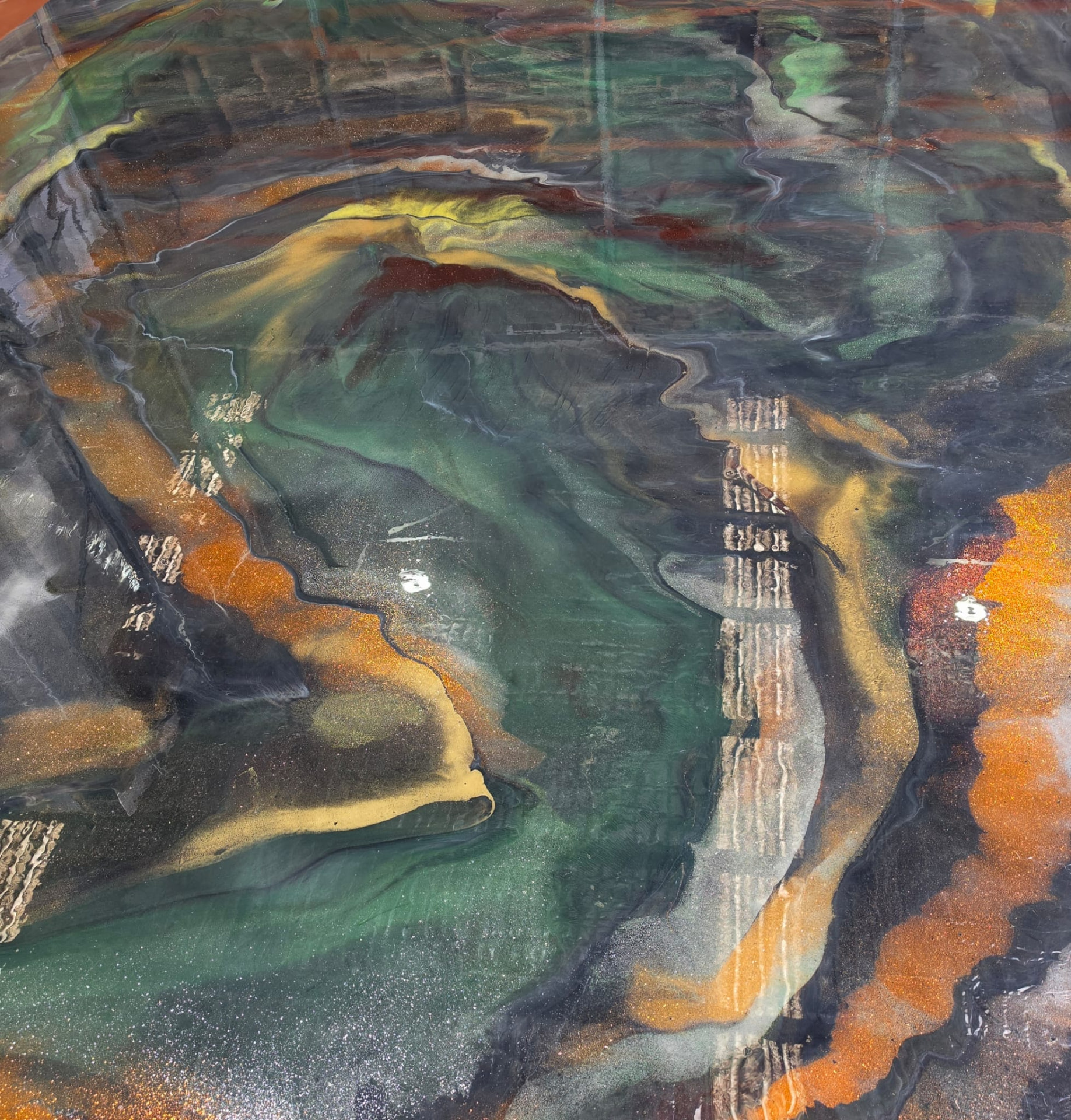 Malachite green and amber metallic epoxy floor with high gloss reflection