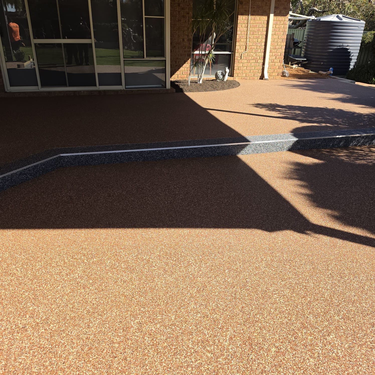 Resin bound step with charcoal riser and a fine white aluminium nosing strip