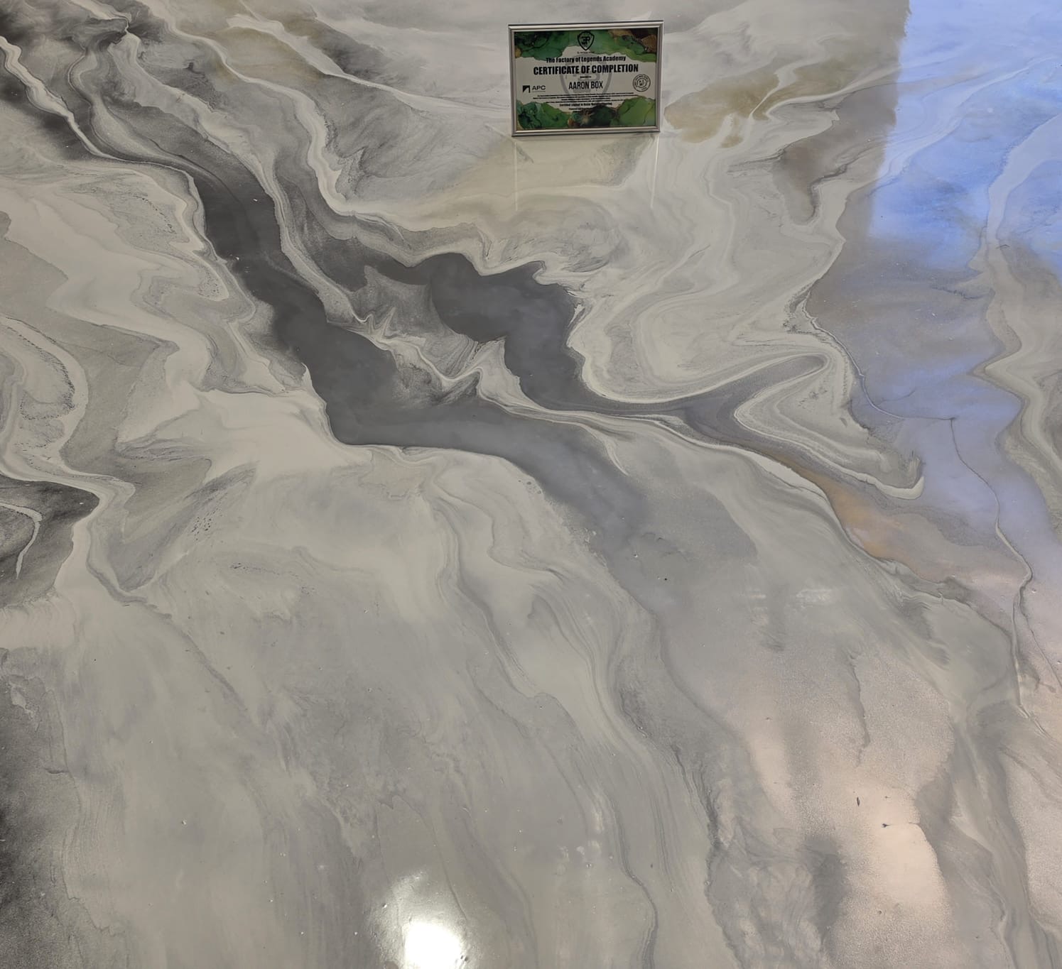 Pearl metallic epoxy floor with soft blue tones reflecting overhead light