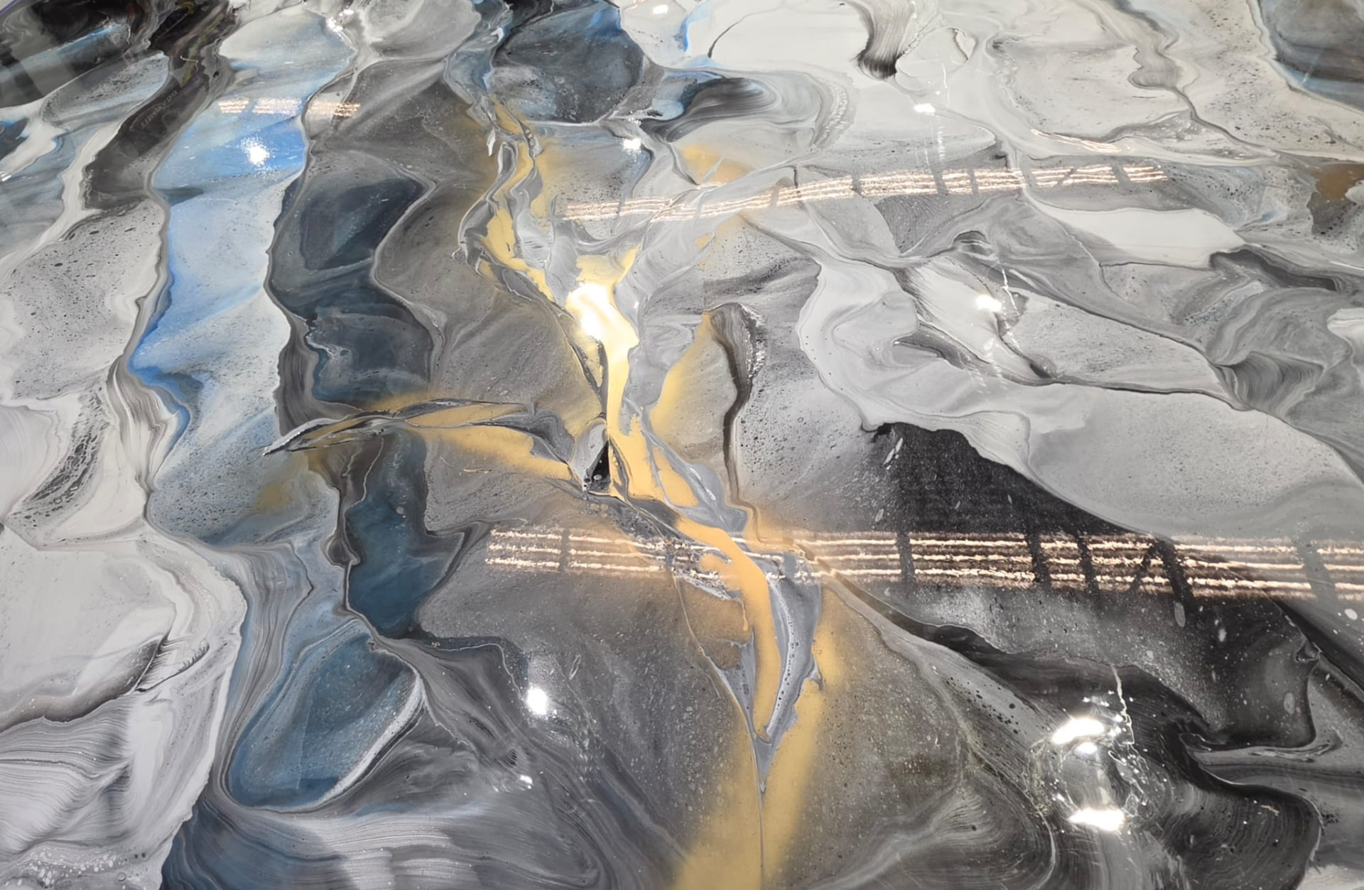 Steel grey metallic epoxy floor with gold veining and blue highlights