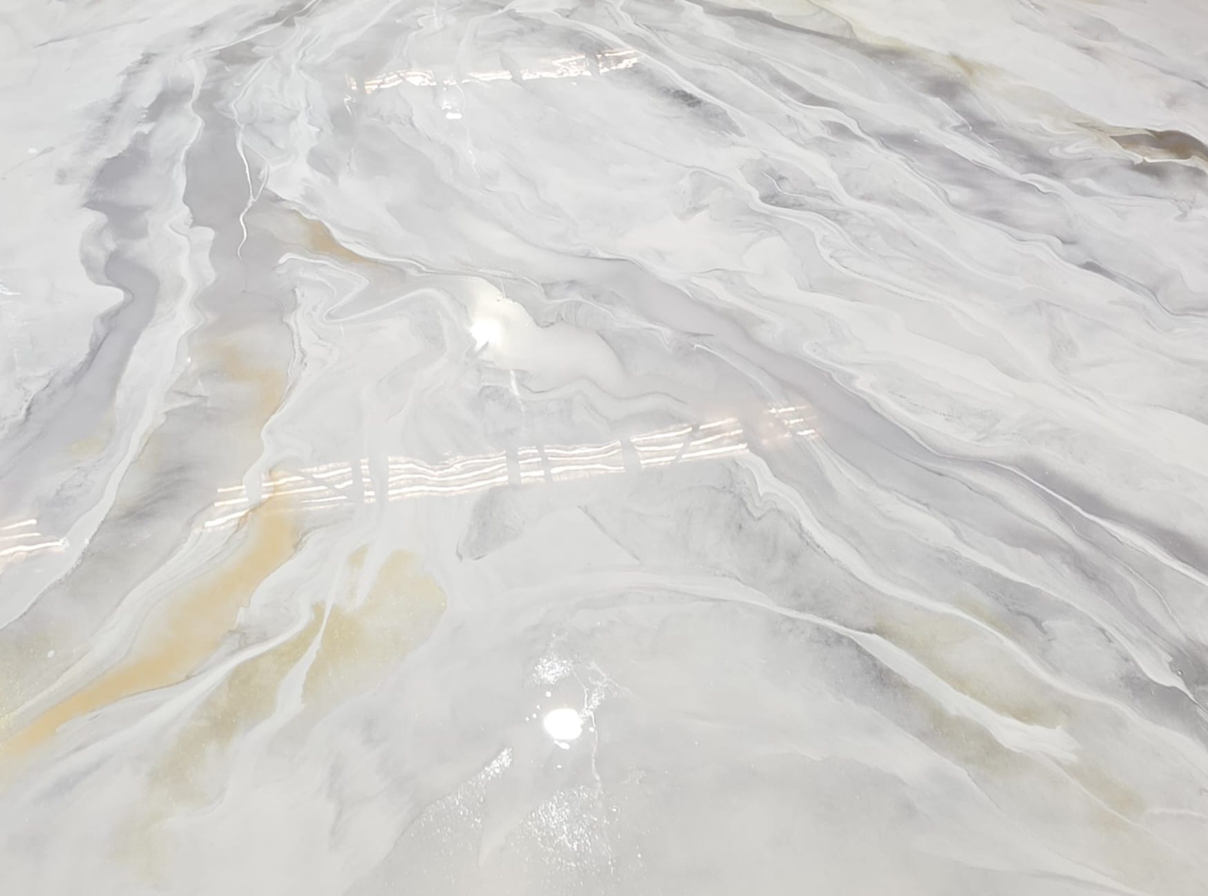 Pale alabaster metallic epoxy floor with warm gold veining